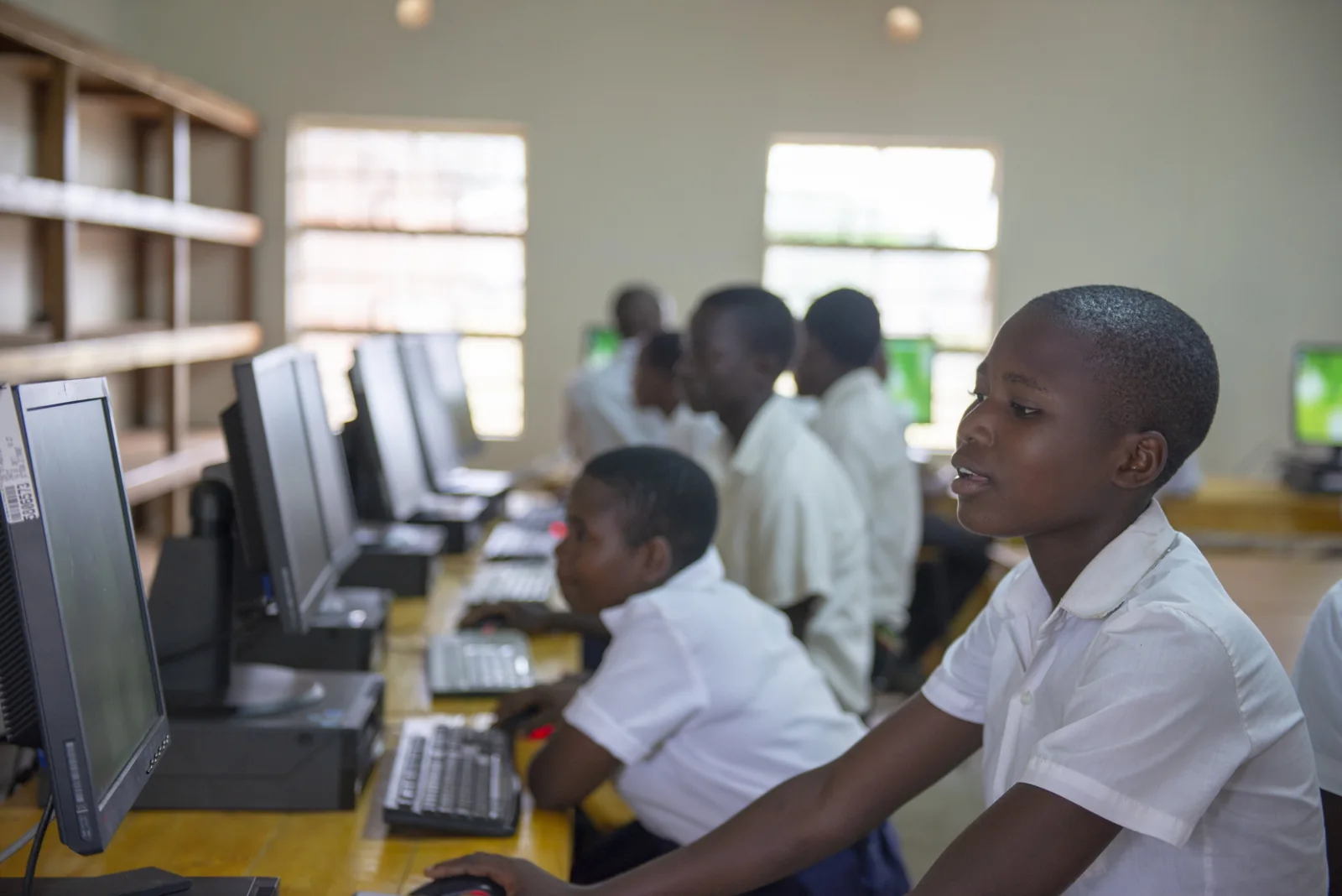 Students practising at desktop computers in Nyungwe Community Day Secondary School, Malawi